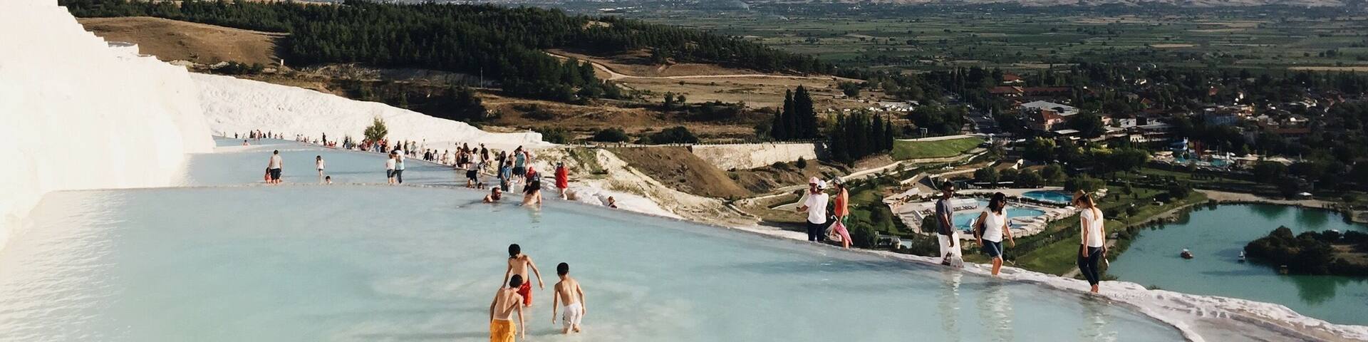 The Pamukkale (meaning Cotton Castle) pools in Turkey are made of travertine terraces formed by calcium carbonate deposits. Near the ancient city of Hierapolis, people have been bathing in the mineral-rich thermal pools for thousands of years. There are 17 pools of varying temperatures. No shoes allowed! #turkey #thermalpool