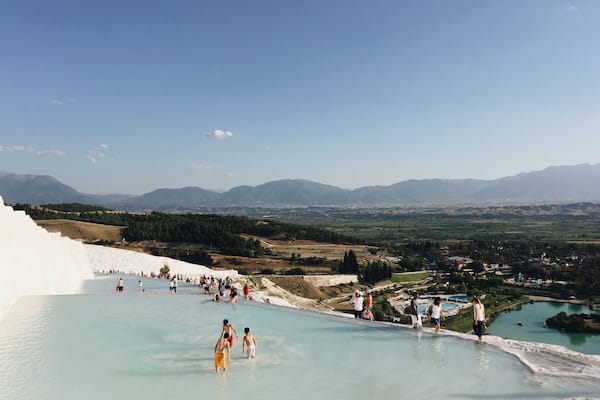 The Pamukkale (meaning Cotton Castle) pools in Turkey are made of travertine terraces formed by calcium carbonate deposits. Near the ancient city of Hierapolis, people have been bathing in the mineral-rich thermal pools for thousands of years. There are 17 pools of varying temperatures. No shoes allowed! #turkey #thermalpool
