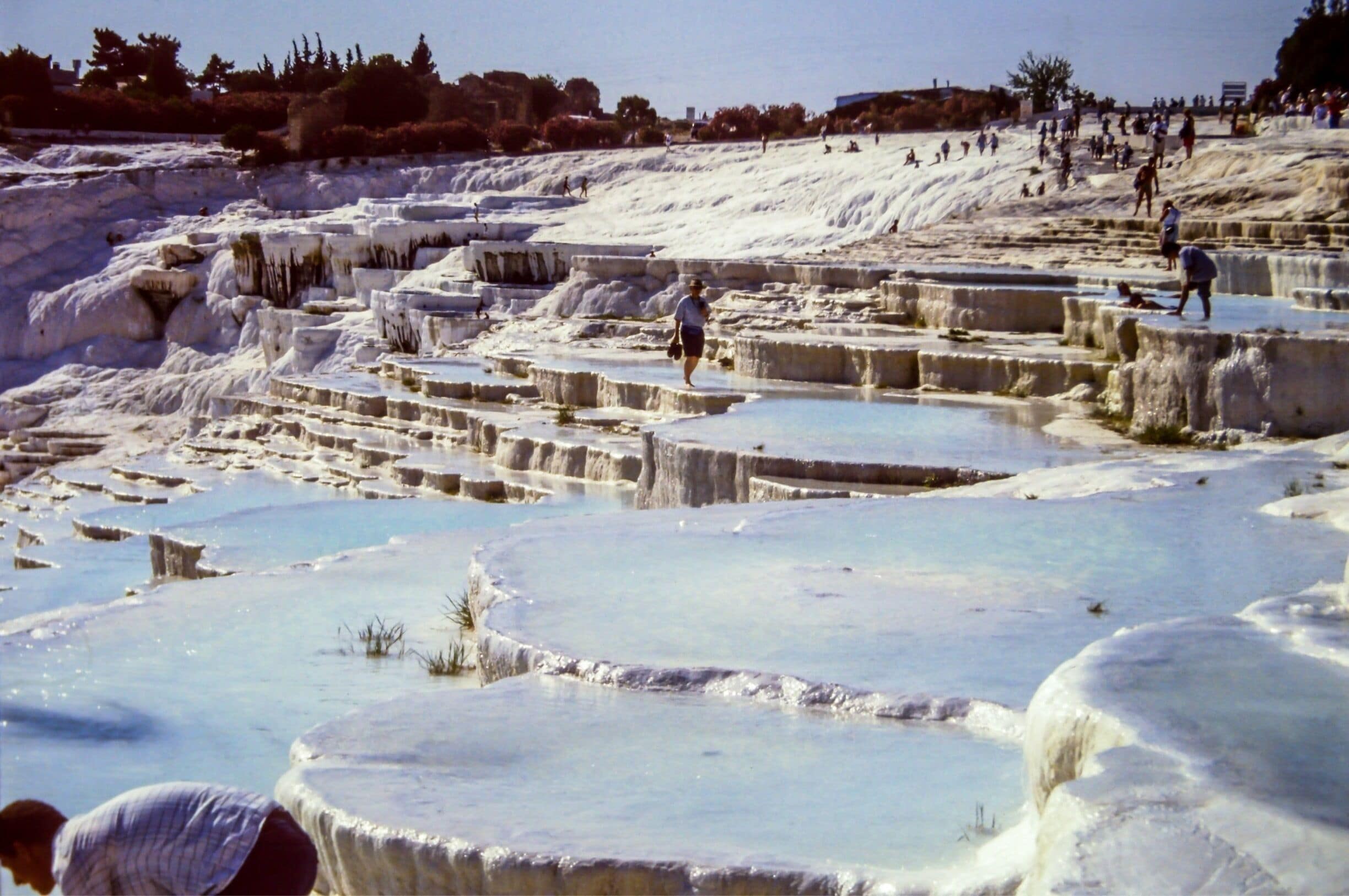 In the early 90 we traveled thru Turkey. On this pictures you'll see the chalk baths of Pamukkale. As you can see in that time you could swim in these baths. That's forbidden these days. When we were there tourism just started in Pamukkale. Now the baths are protected by law. 
This picture was taken on a dia positive film wich I digitalised some time ago.

#pamukkale #turkey #asia #europe #white
