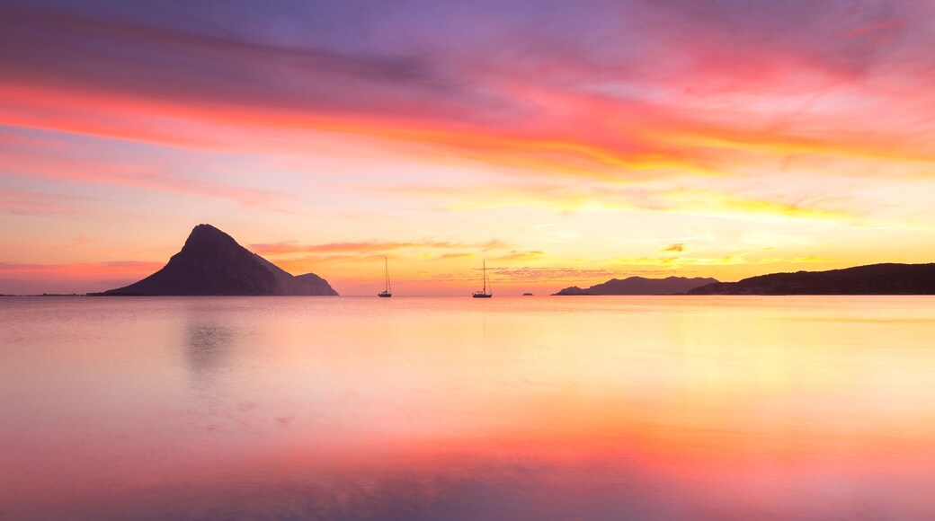 Amazing sunrise on the beach of Porto Taverna with the Tavolara Island in the background, Loiri Porto San Paolo, Olbia Tempio province, Sardinia, Mediterranean