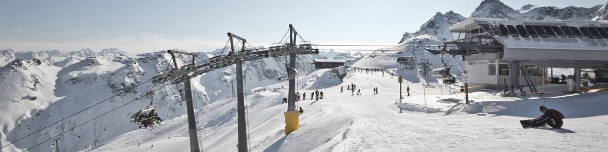Montafon - Wonderful weather for winter sport action in Austria. Great view over some mountain ranges and peaks in a awesome snow landscape. Snowboarder. Skier.