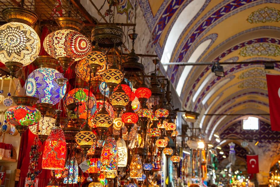 A market with colorful hanging lanterns and a Turkish flag.