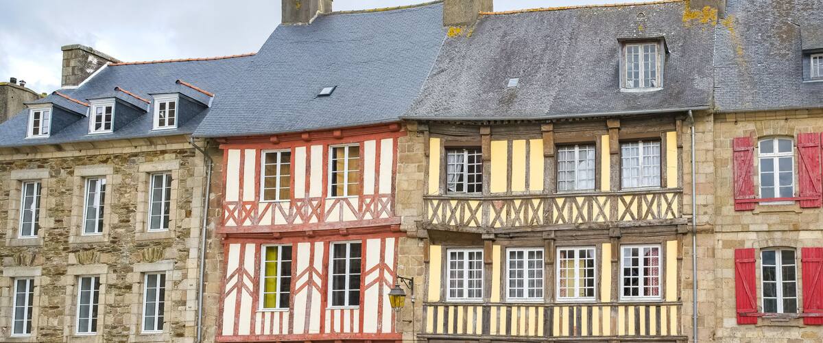 A row of half-timbered buildings with red and yellow facades.