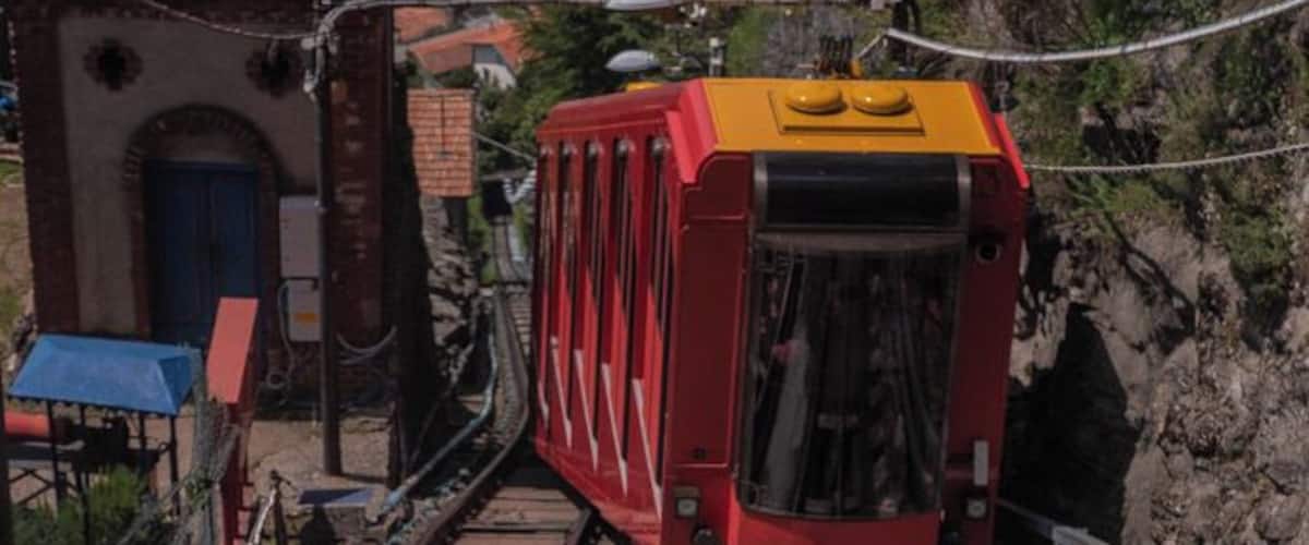 The cross over point half way through the journey to the top. The Como–Brunate funicular is a funicular railway that connects the city of Como with the village of Brunate in Lombardy, Italy. The line has operated since 1894, and is used by both tourists and local residents.