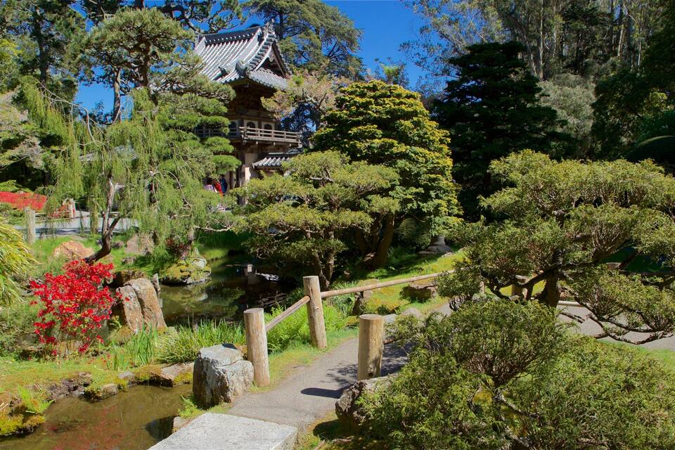 A traditional Japanese garden with a pagoda, koi pond, and various trees.