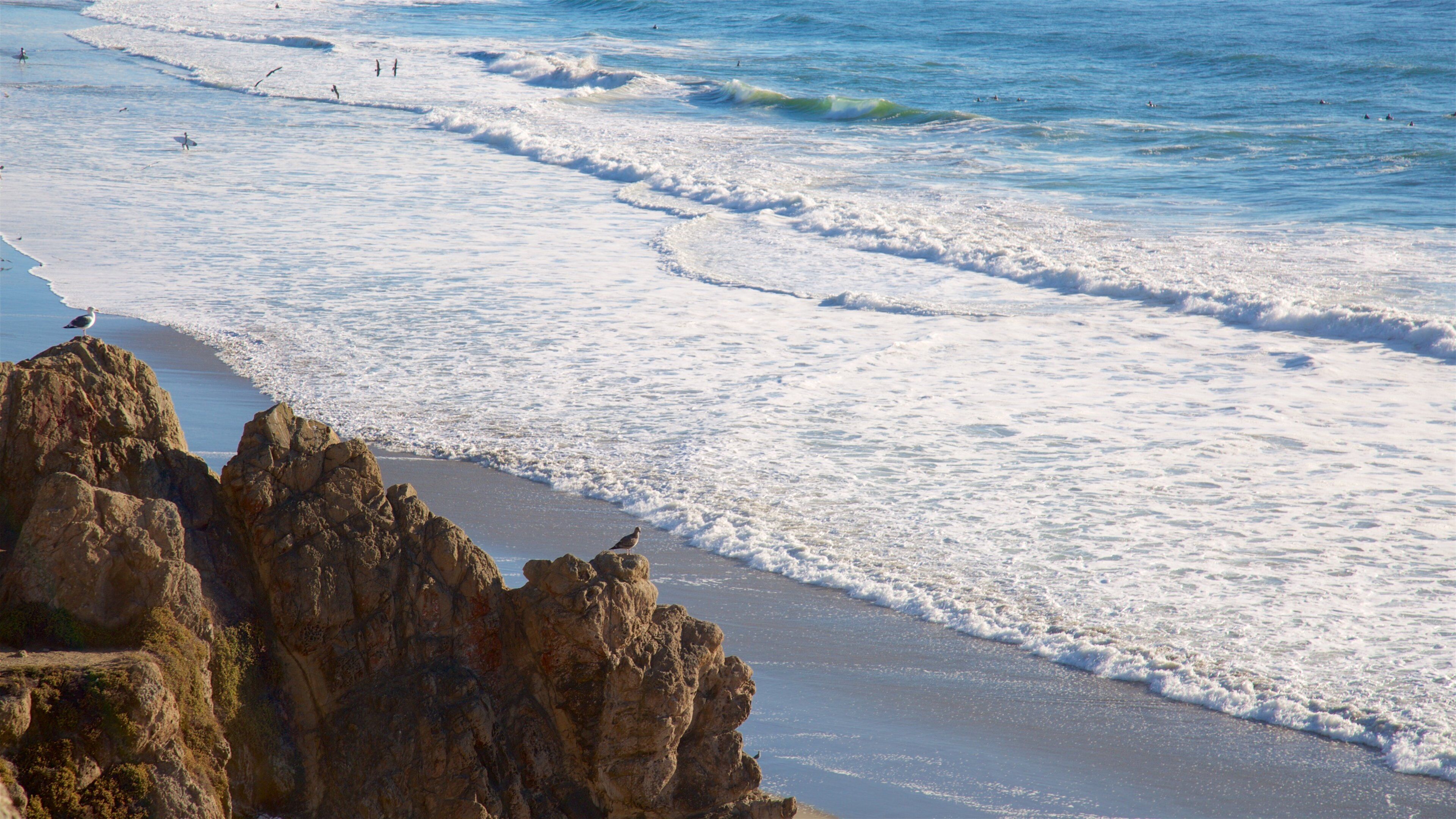 A rocky coastline with waves crashing onto the shore.