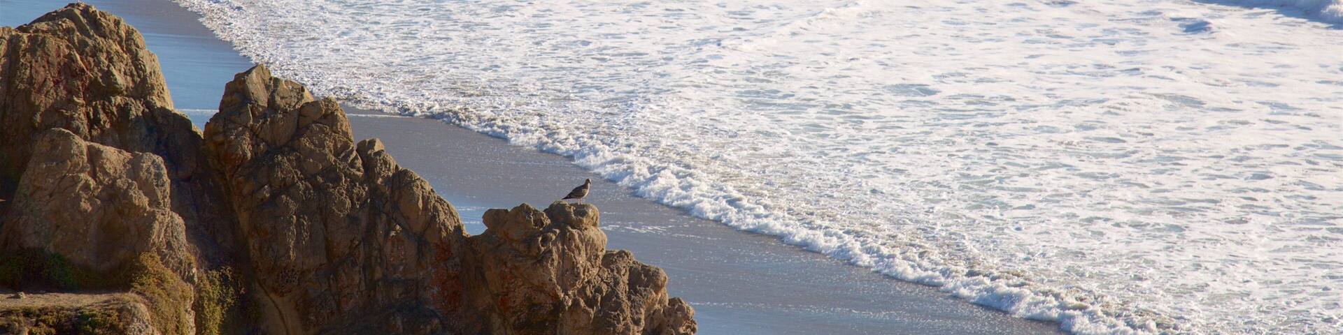 A rocky coastline with waves crashing onto the shore.