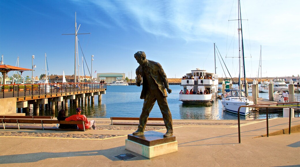 Jack London Square which includes a bay or harbor and a statue or sculpture