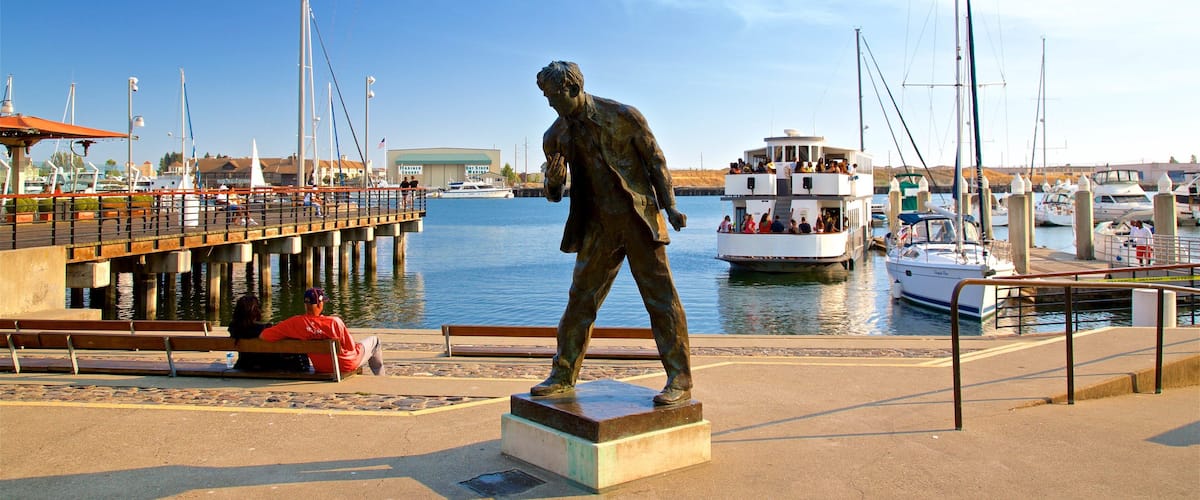 Jack London Square which includes a bay or harbor and a statue or sculpture