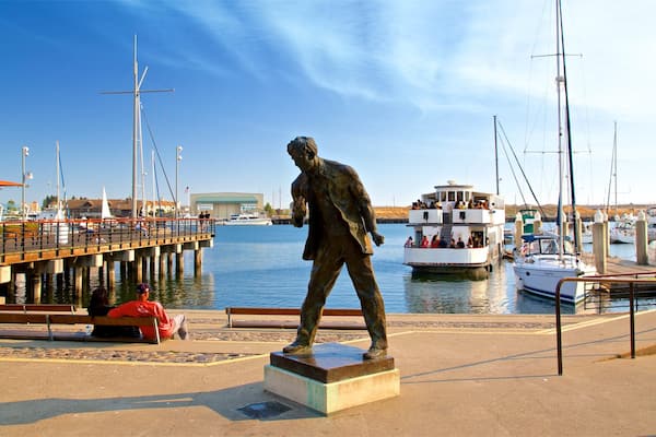 Jack London Square which includes a bay or harbor and a statue or sculpture