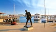 Jack London Square which includes a bay or harbor and a statue or sculpture