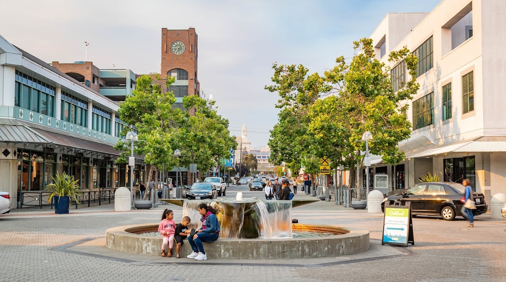 Jack London Square featuring a fountain as well as a family