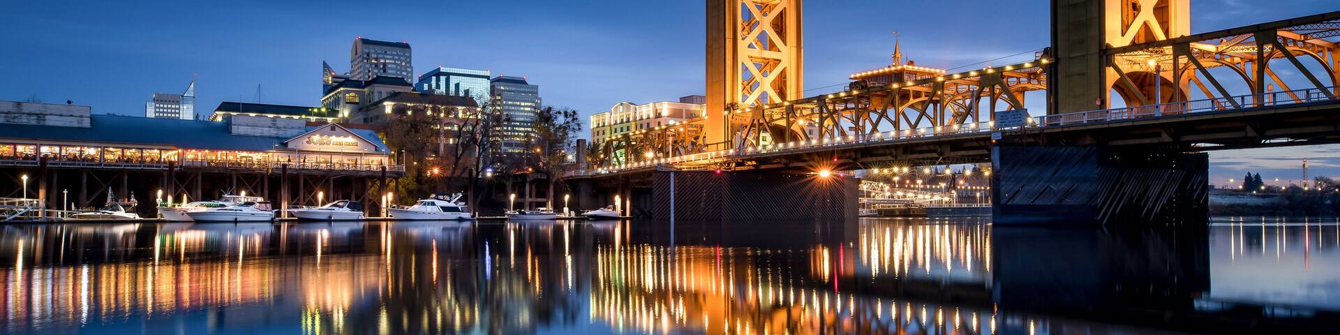 Sacramento Tower Bridge in the twilight with the Ziggurat Building in the background, Riverfront Park, West Sacramento.