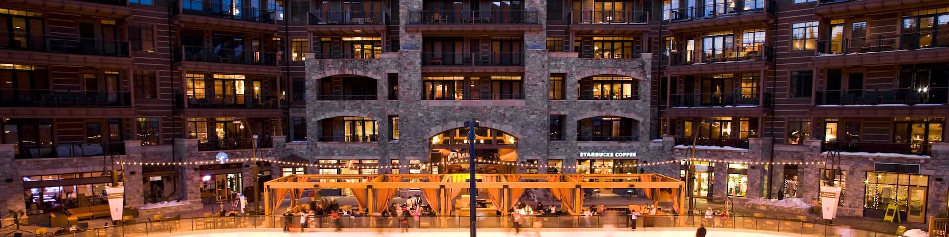 Northstar California Resort featuring a hotel and ice skating as well as a small group of people