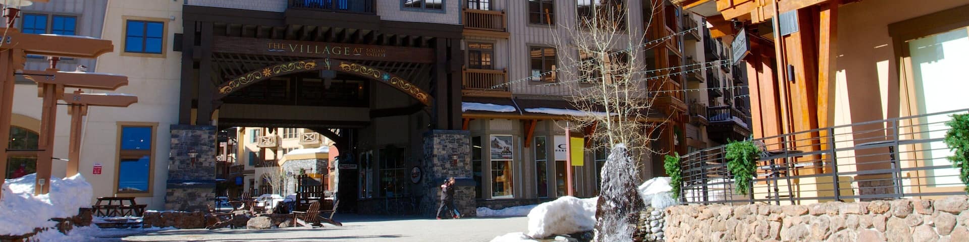 A snow-covered building with a sign reading "The Village at Squaw Valley."
