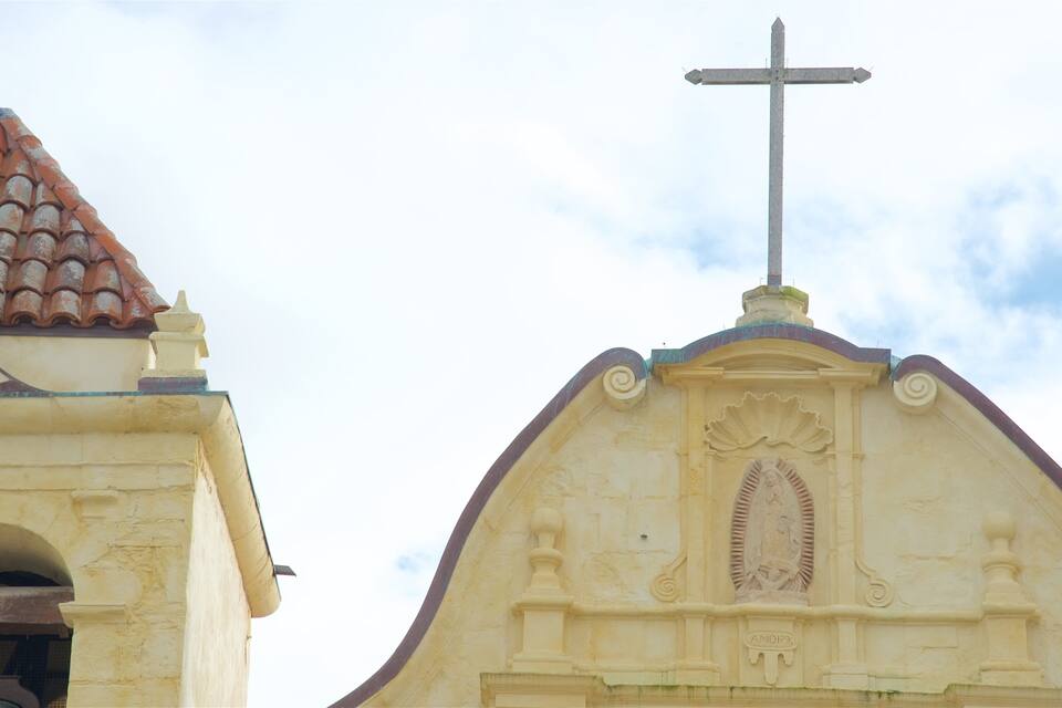 A church with a cross on top and a tiled roof.