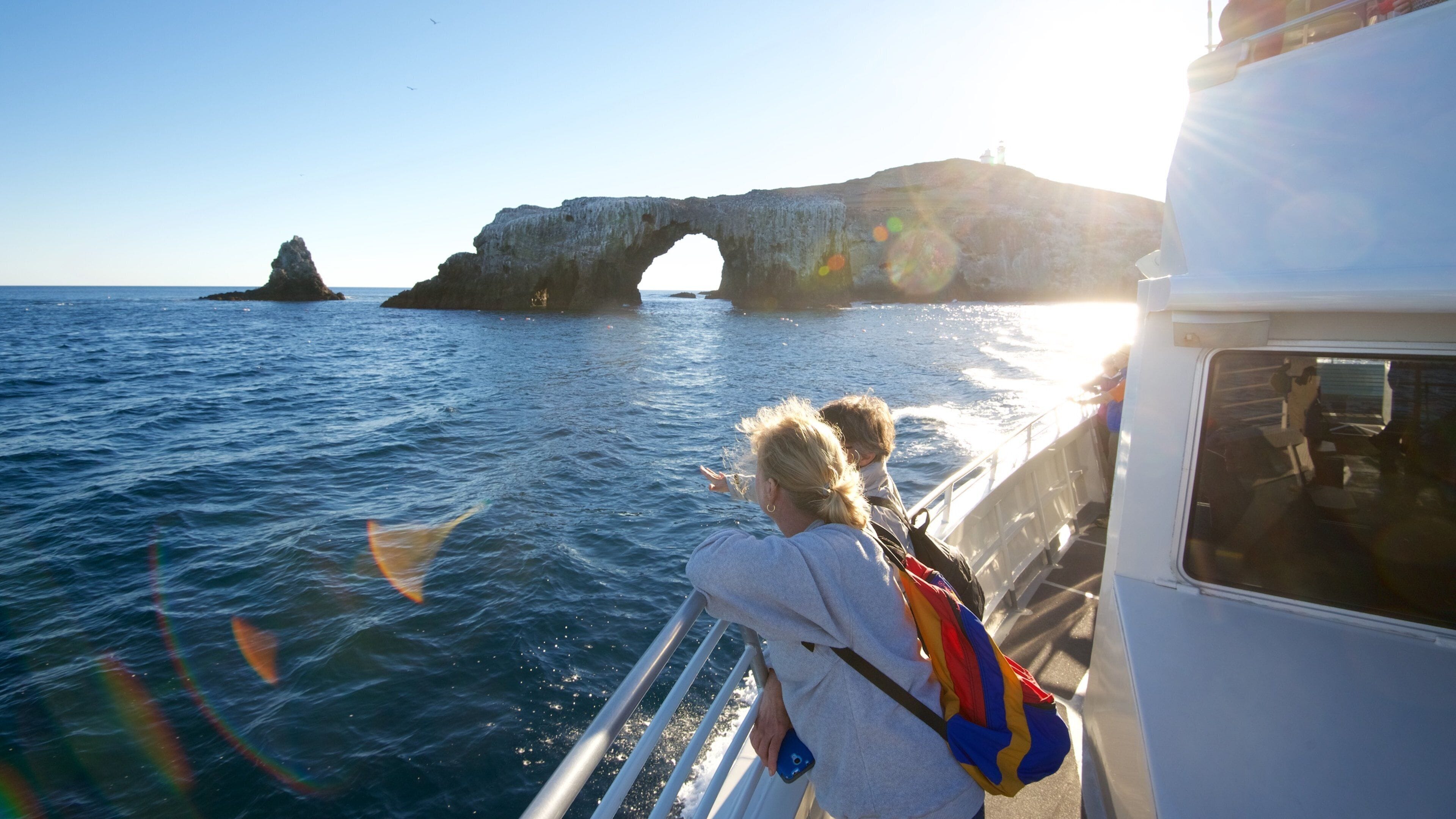 A rocky coastline with a large arch formation and the ocean.