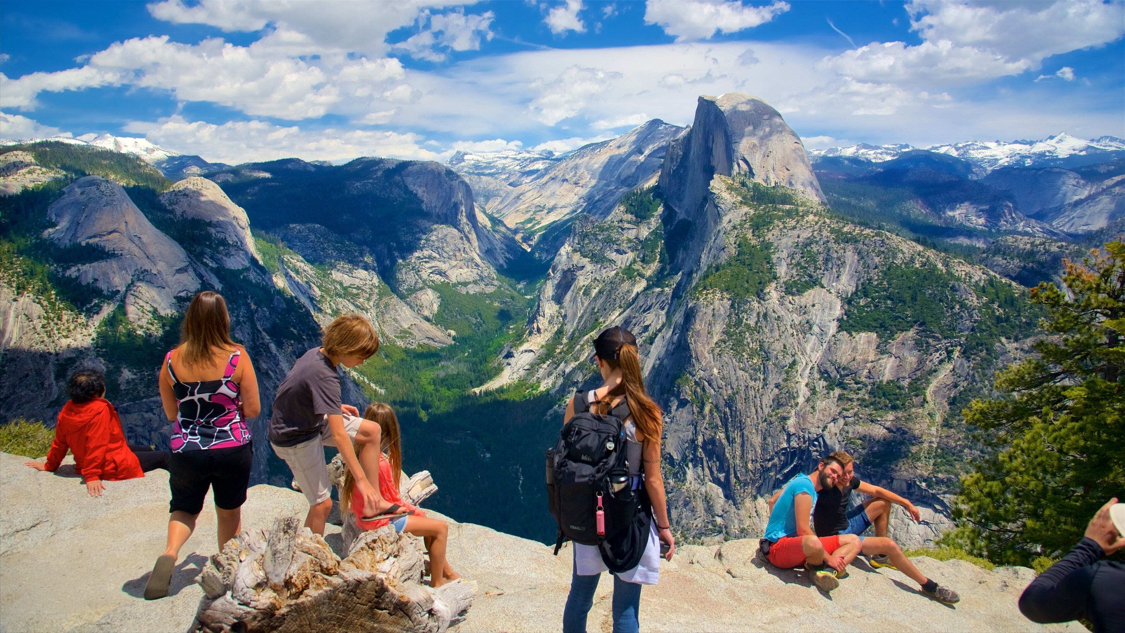 Glacier Point featuring landscape views and mountains as well as a large group of people
