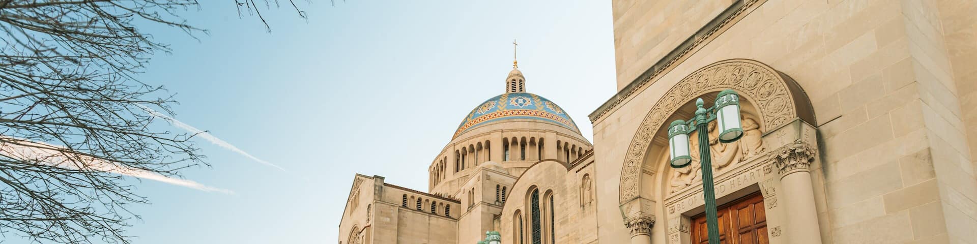 A large, historic building with a prominent dome and arched windows.