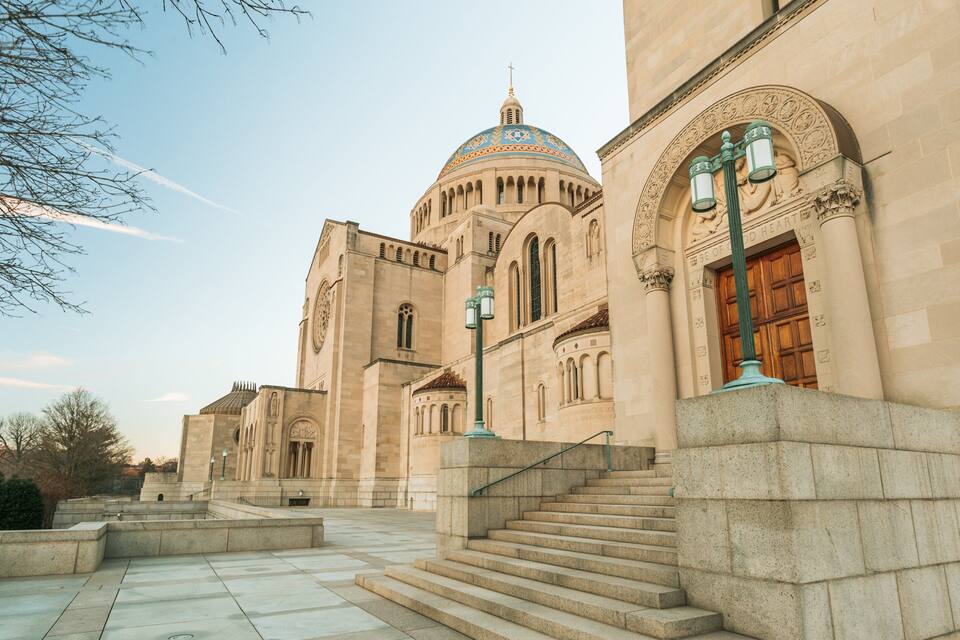 A large, historic building with a prominent dome and arched windows.