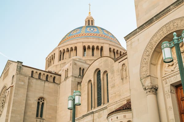 A historic building with a large dome, arched windows, and intricate stonework.