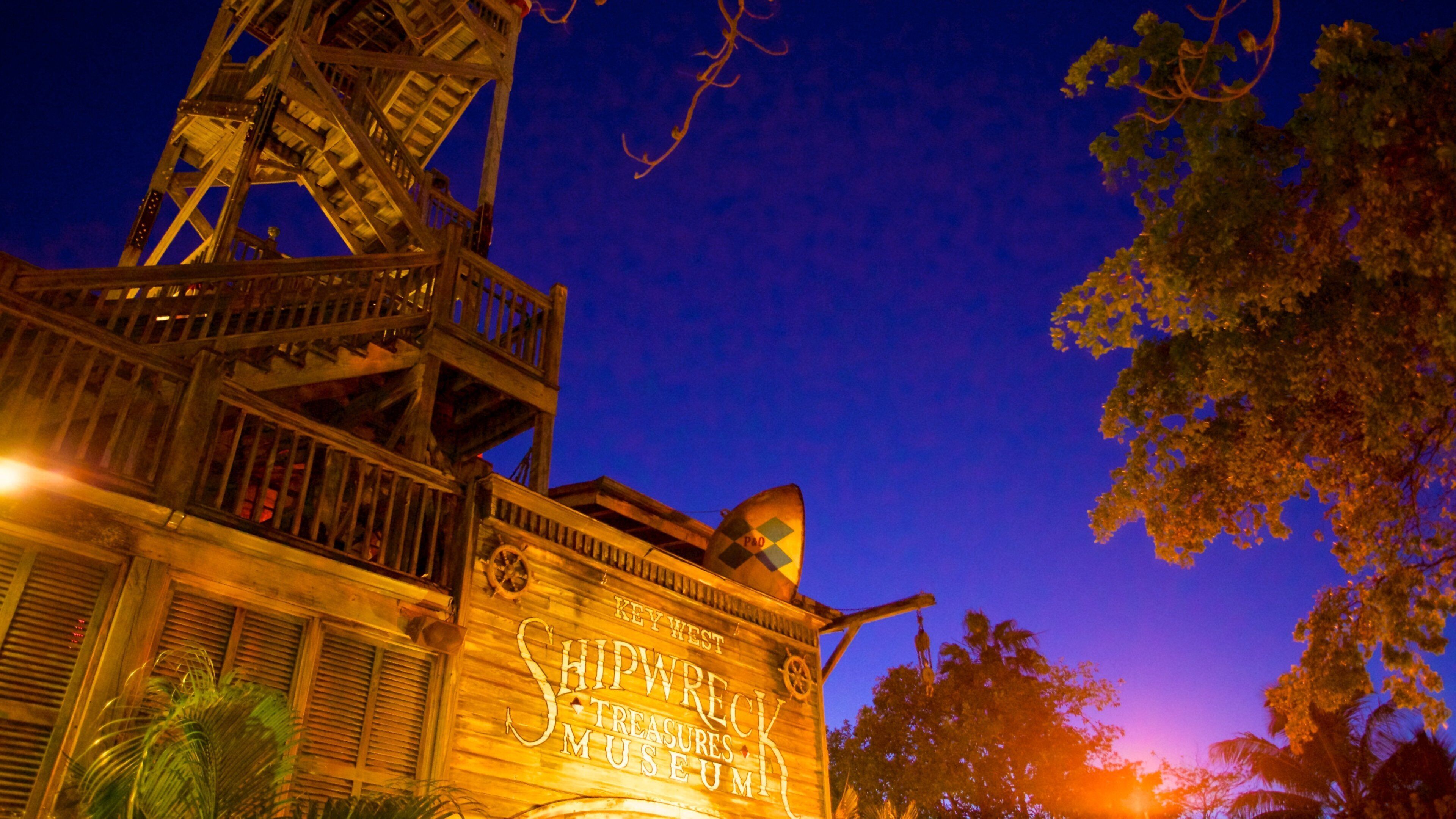 Key West Shipwreck Museum which includes signage and a sunset