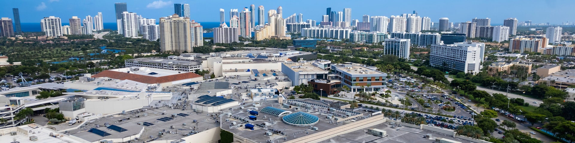 Aventura, Florida, USA - Aerial of Aventura Mall, with skyline of Sunny Isles Beach in the distance.