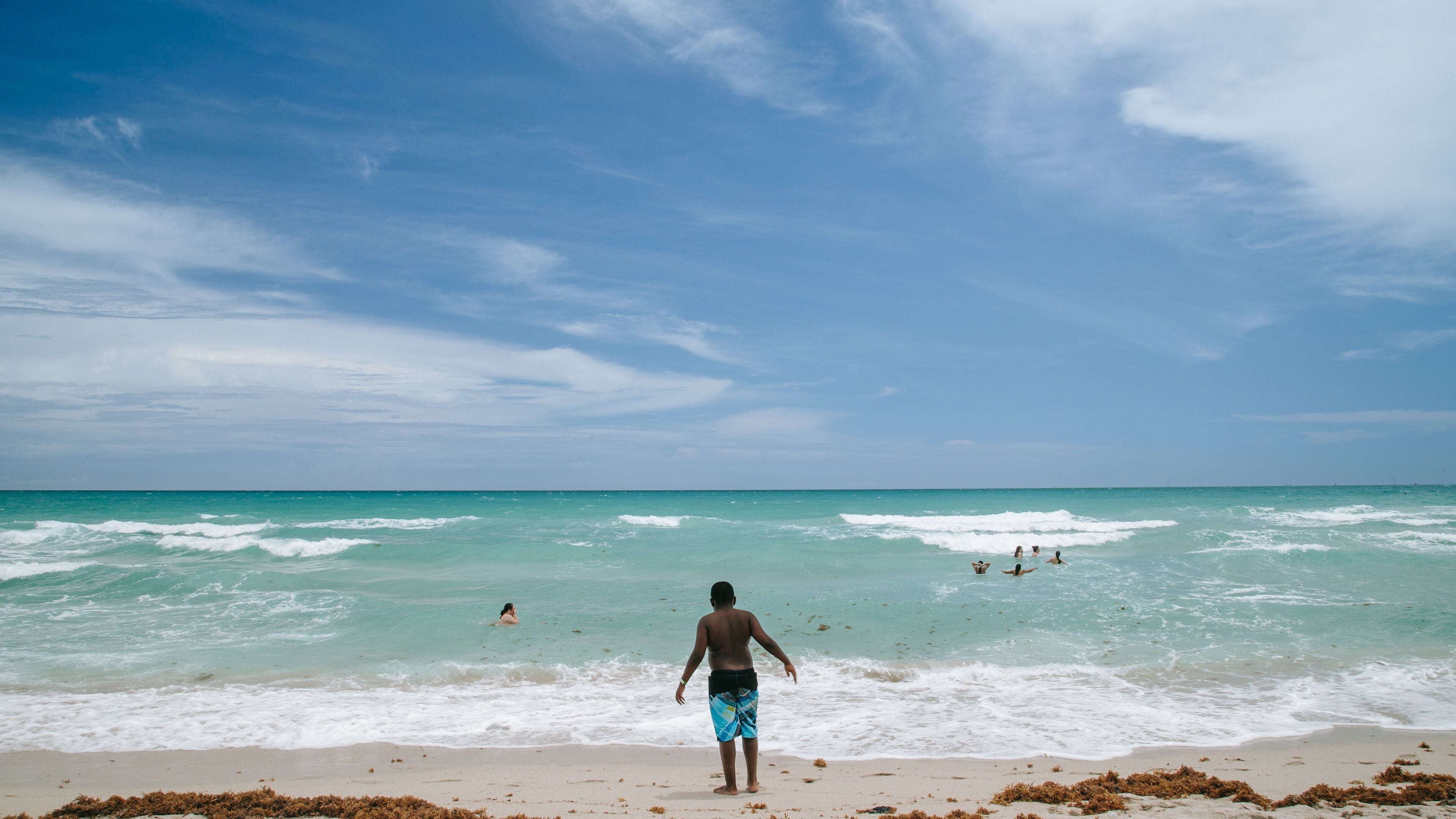 Lummus Park Beach which includes swimming, general coastal views and a sandy beach