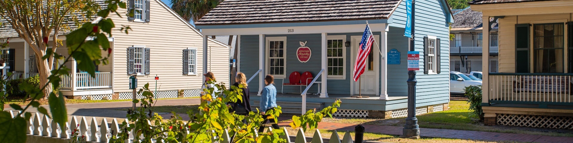 Historic Pensacola Village which includes street scenes and a house as well as a small group of people
