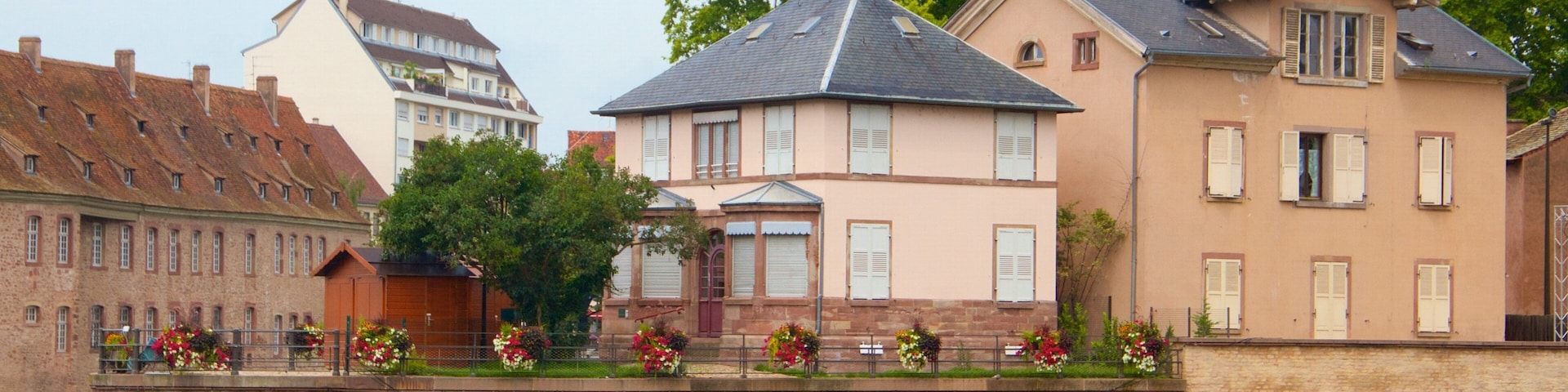 Covered Bridge featuring a small town or village and a river or creek