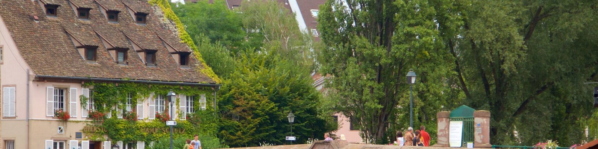 Covered Bridge featuring a small town or village, a river or creek and a bridge