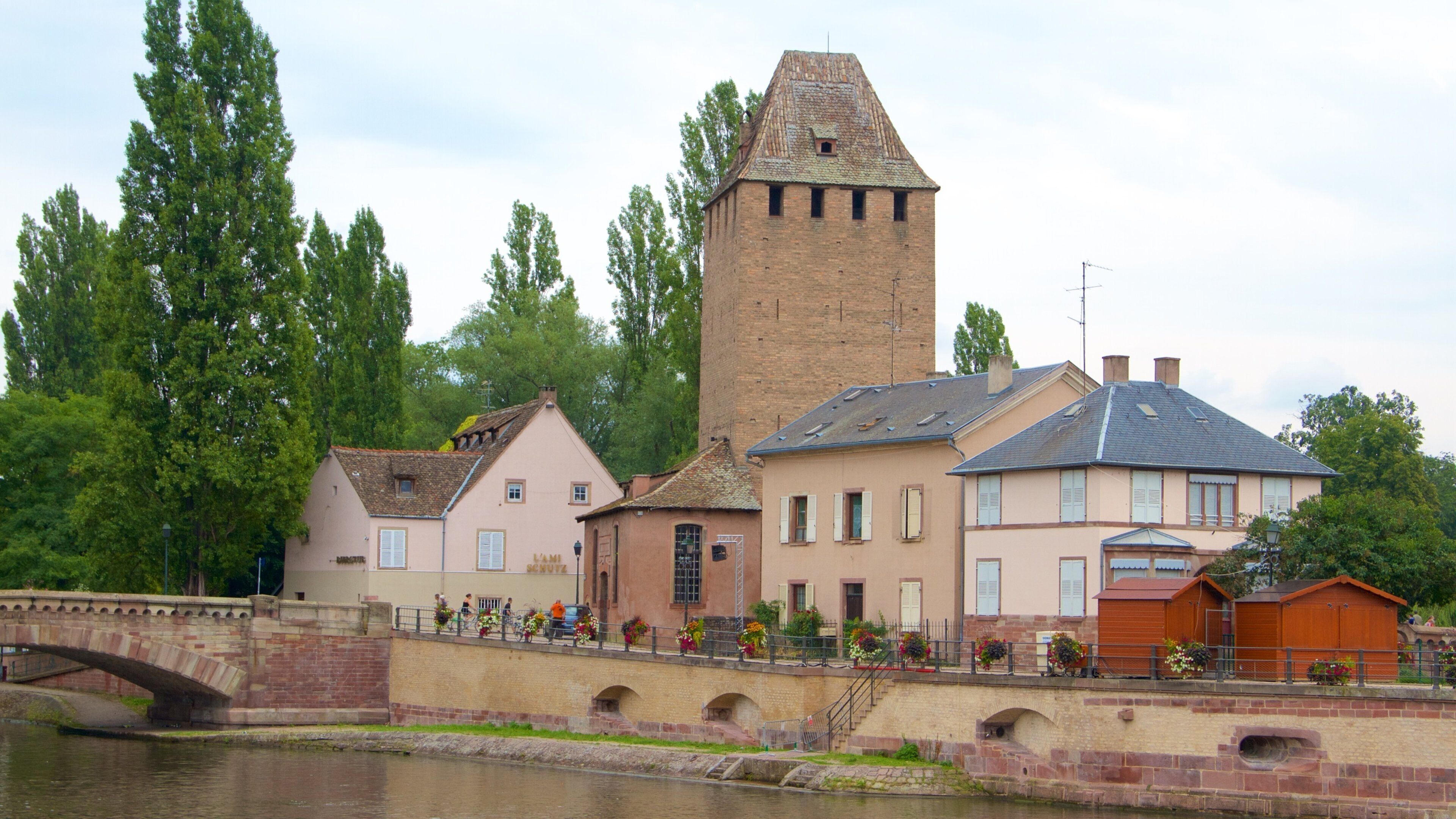 Covered Bridge featuring a river or creek, a bridge and a small town or village