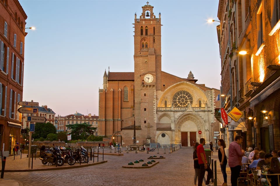 A historic church with a tall bell tower and a large rose window.