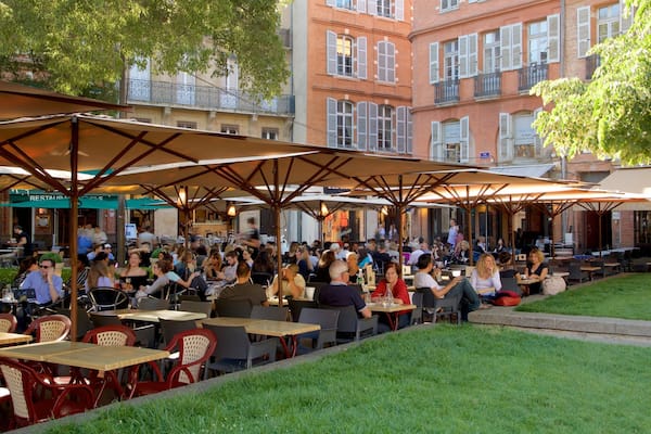 Saint George Place which includes outdoor eating as well as a large group of people