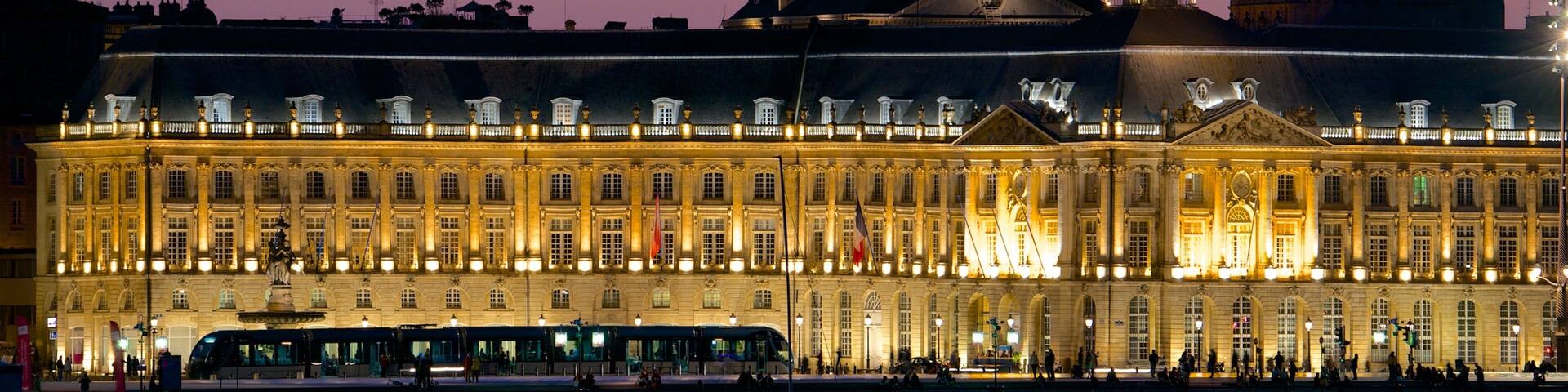 Place de la Bourse showing heritage architecture, night scenes and an administrative buidling