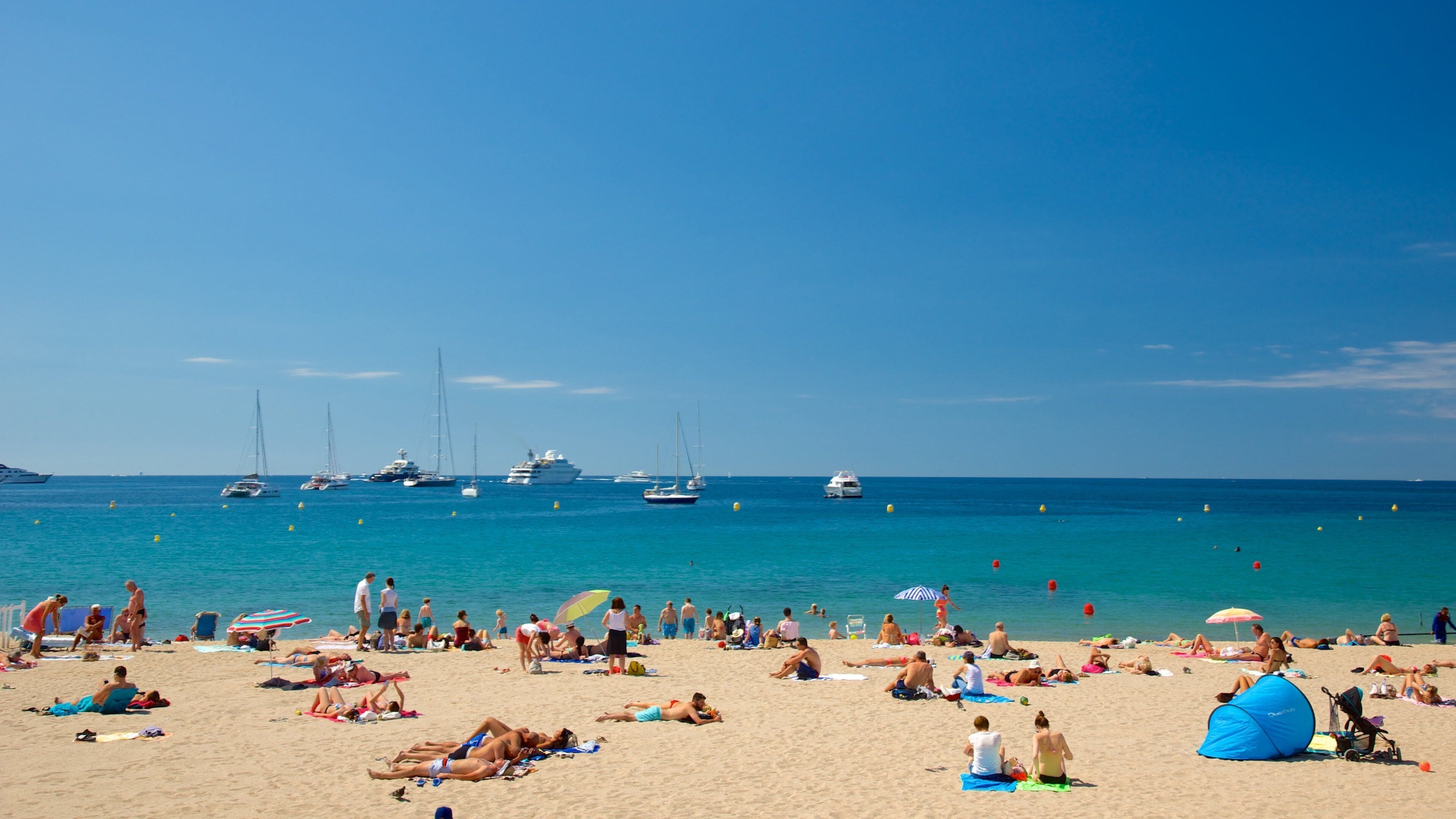 Croisette Beach featuring a bay or harbor and a sandy beach
