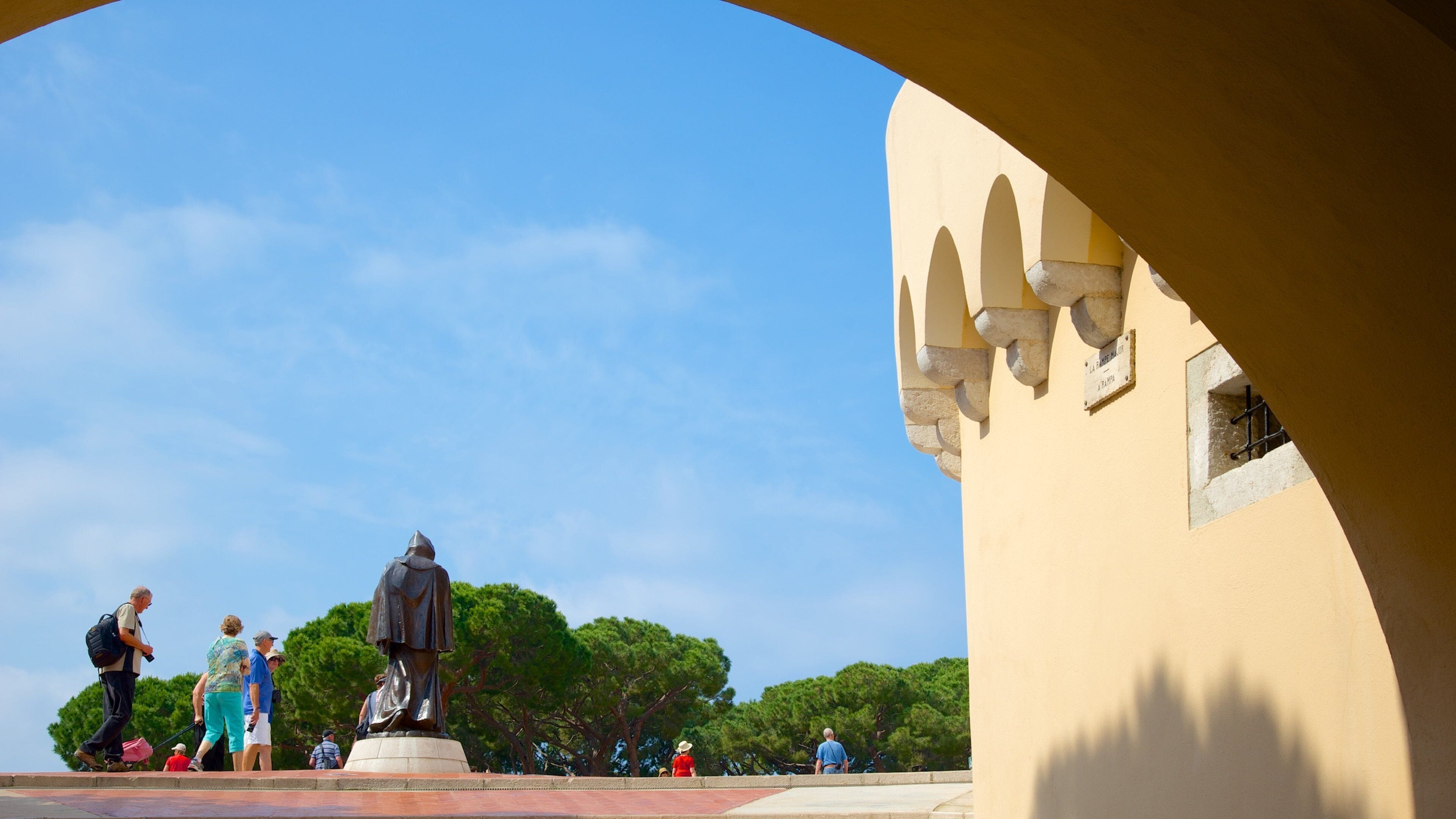 Palace Square showing a statue or sculpture as well as a small group of people