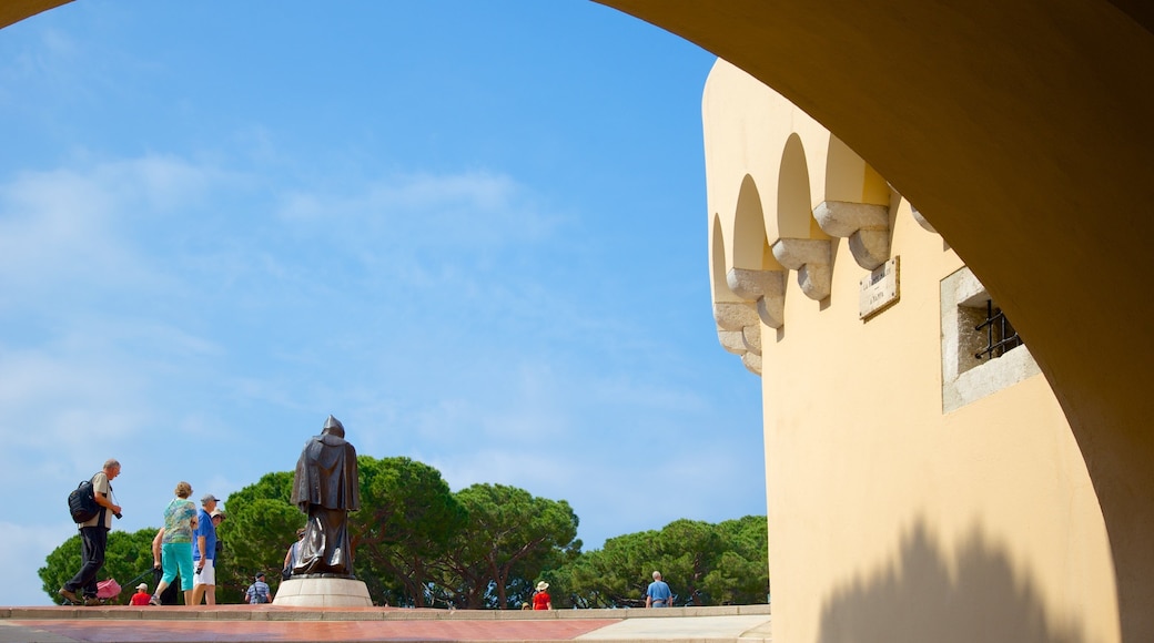 Palace Square showing a statue or sculpture as well as a small group of people