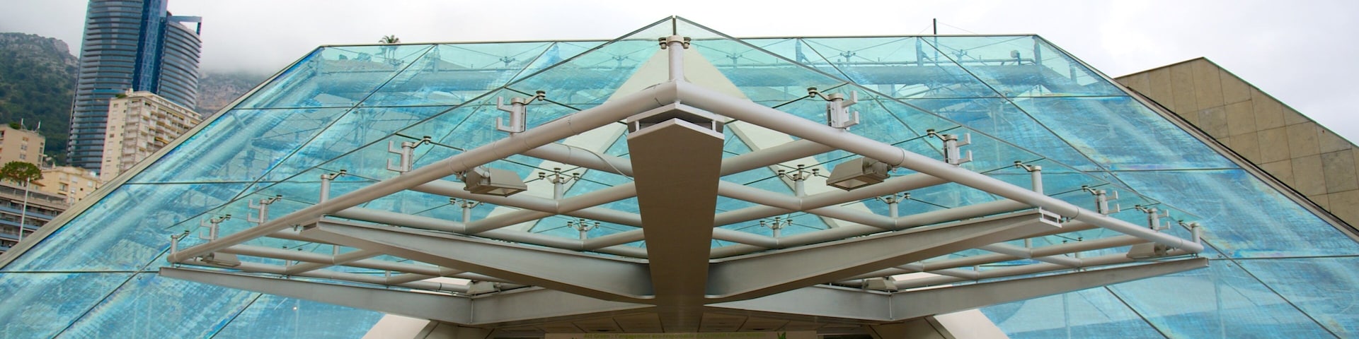 Um edifício moderno de vidro com uma estrutura de entrada geométrica.