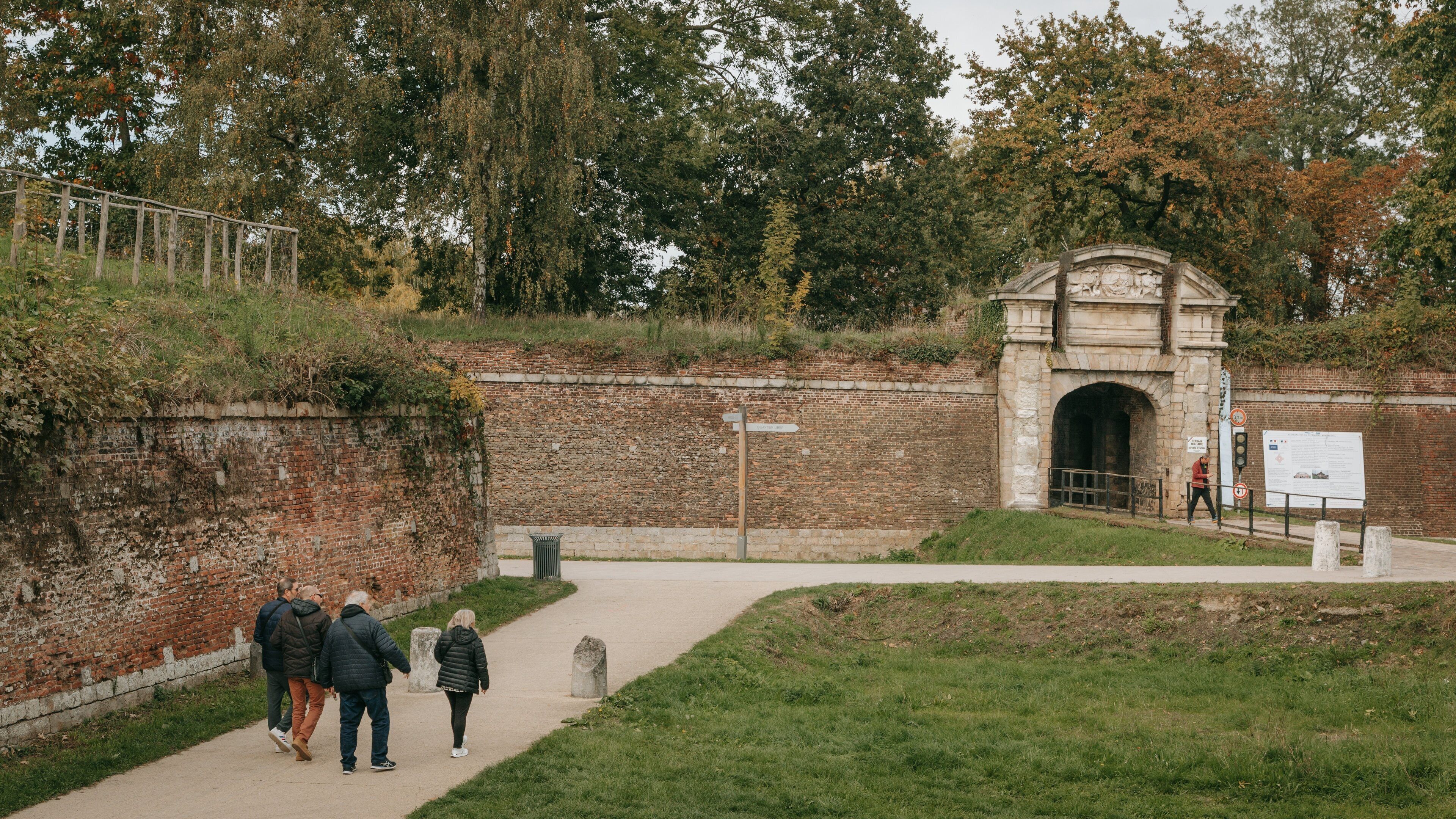 Citadel of Lille featuring a garden as well as a small group of people
