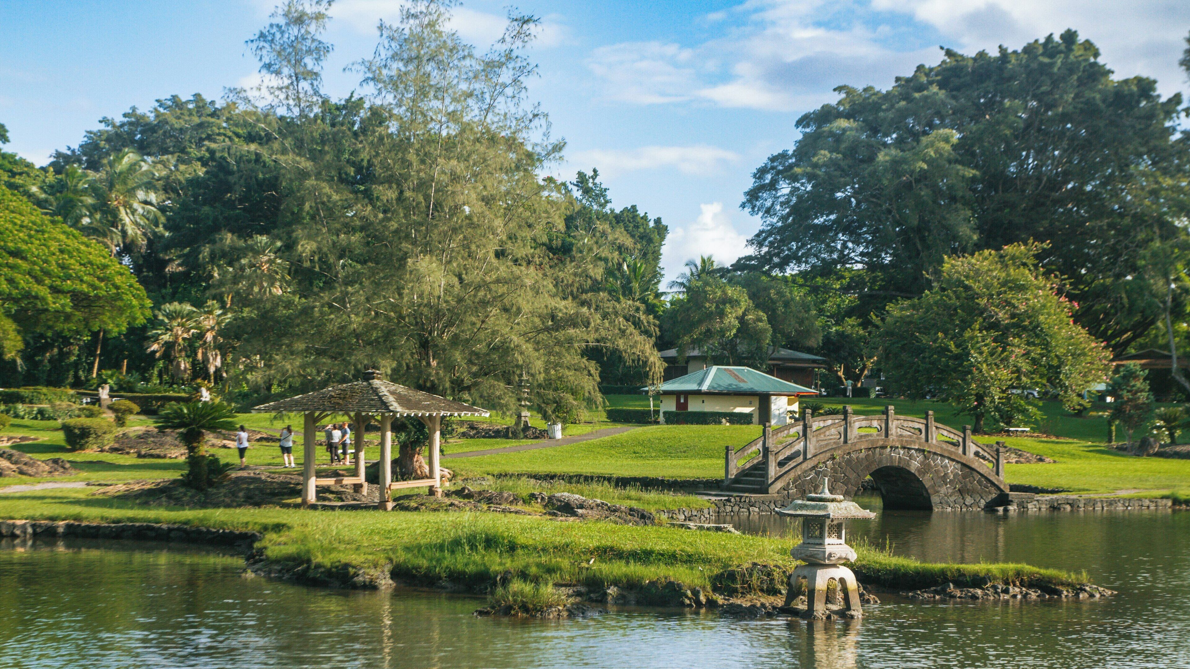 Peaceful strolls and lush gardens await visitors at Liliuokalani Park and Gardens in Hilo, Hawaii, showcasing harmonious landscapes and traditional architecture