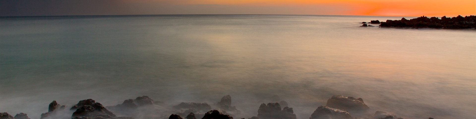 Hapuna Beach State Park showing general coastal views, a sunset and rocky coastline