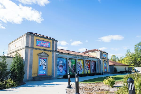 The Chicago Zoological Park building with colorful murals of animals and a clear blue sky.