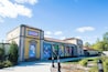 The Chicago Zoological Park building with colorful murals of animals and a clear blue sky.