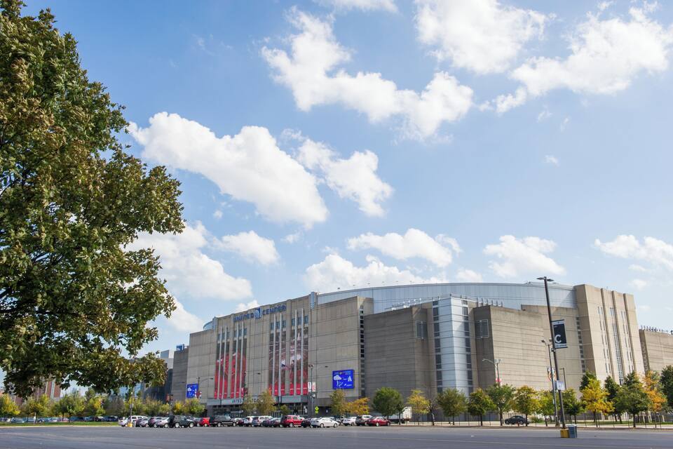 A large, modern building with a curved facade and multiple vertical windows.