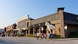 A street with a building labeled "Woodfield Mall" and a horse statue.