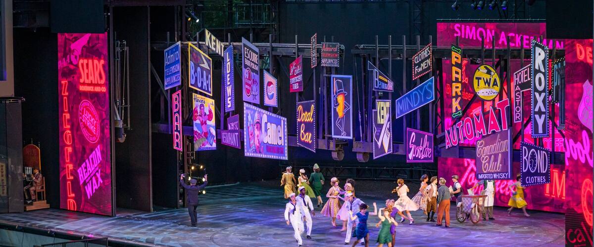 The Muny Theater featuring theater scenes and performance art as well as a small group of people