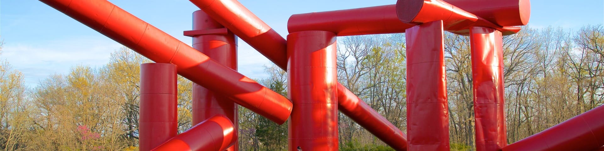 Laumeier Sculpture Park featuring a garden and outdoor art as well as an individual femail