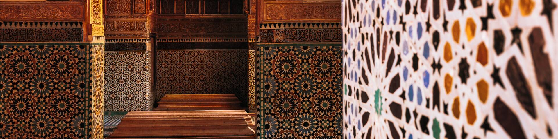 An ornate archway with intricate tile work and a patterned wall.