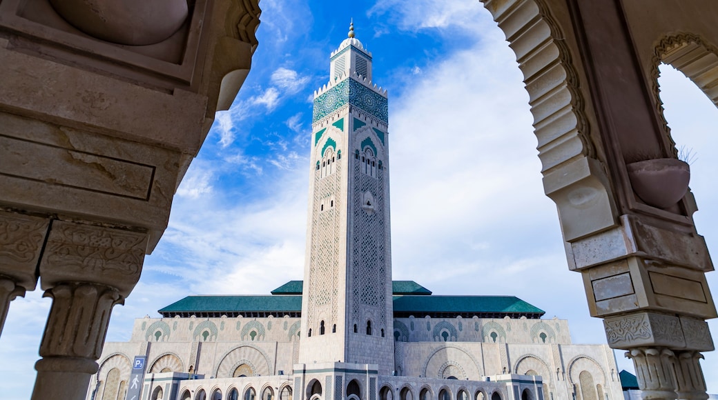 View of Hassan II mosque against blue sky - The Hassan II Mosque or Grande Mosquée Hassan II is a mosque in Casablanca, Morocco.